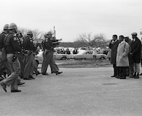 Alabama state troopers initiating assault on peaceful black marchers on the Edmund Pettus Bridge in March 1965